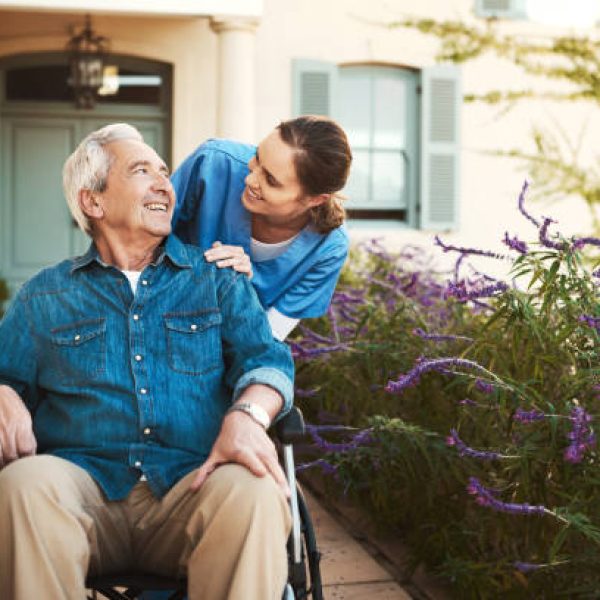 Cropped shot of a young female nurse outside with a senior patient in a wheelchair